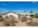 Single-story home with desert landscaping, under a clear blue sky at 1845 N 64Th St, Scottsdale, AZ 85257
