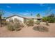 Single-story home with xeriscaped front yard and desert landscaping under a blue sky at 1845 N 64Th St, Scottsdale, AZ 85257