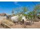 Single-story home with xeriscaping, mature trees, and a block wall at 1845 N 64Th St, Scottsdale, AZ 85257