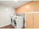 Bright laundry room with washer, dryer, and storage cabinets at 1845 N 64Th St, Scottsdale, AZ 85257