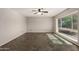 Living room featuring tile flooring, ceiling fan, and a large window at 1845 N 64Th St, Scottsdale, AZ 85257
