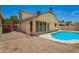 Backyard with pool, gravel area, and privacy fence with lush plants at 19230 N 5Th St, Phoenix, AZ 85024