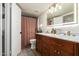 Bright bathroom with wooden vanity, marble countertop, and illuminated mirror at 19230 N 5Th St, Phoenix, AZ 85024
