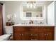 Bright bathroom with wooden vanity, marble countertop, and illuminated mirror at 19230 N 5Th St, Phoenix, AZ 85024