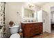 Updated bathroom with wooden vanity, marble countertop, and illuminated mirror at 19230 N 5Th St, Phoenix, AZ 85024