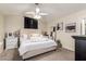 Comfortable bedroom with ceiling fan, tufted headboard and a neutral color palette at 19230 N 5Th St, Phoenix, AZ 85024