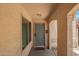 Covered entry with a blue front door, window and a desert landscape entry mat at 19230 N 5Th St, Phoenix, AZ 85024
