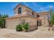 Two-story home with a two-car garage, desert landscaping, arched windows and entry at 19230 N 5Th St, Phoenix, AZ 85024
