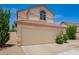 Two-story home with a two-car garage, desert landscaping, arched window and tile roof at 19230 N 5Th St, Phoenix, AZ 85024