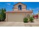 Two-story home with a two-car garage, desert landscaping and an arched window above at 19230 N 5Th St, Phoenix, AZ 85024