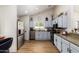 Spacious kitchen with stainless steel appliances and white cabinetry at 19230 N 5Th St, Phoenix, AZ 85024