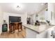 Kitchen with stainless appliances, an island counter with barstools, and wood flooring at 19230 N 5Th St, Phoenix, AZ 85024