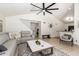 Open-concept living room featuring tile floors, neutral colors, and a large comfortable sofa at 19230 N 5Th St, Phoenix, AZ 85024