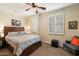 Comfortable bedroom featuring a ceiling fan, carpeted floors, shuttered windows, and a cozy atmosphere for relaxation at 2470 E Roma Ave, Phoenix, AZ 85016