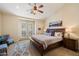 Comfortable bedroom with natural light, carpeted floors, and french doors, creating a serene and inviting retreat at 2470 E Roma Ave, Phoenix, AZ 85016