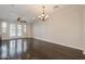Large bonus room with dark wood floors, neutral walls, modern lighting, and french doors for a versatile living space at 2470 E Roma Ave, Phoenix, AZ 85016
