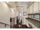 Hallway with dark wood floors, and a convenient built-in desk, offering functionality and style at 2470 E Roma Ave, Phoenix, AZ 85016