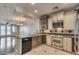 Updated kitchen features granite counters, stainless steel appliances, and two-tone cabinets with an open concept at 2470 E Roma Ave, Phoenix, AZ 85016