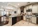 Updated kitchen features granite counters, stainless steel appliances, and two-tone cabinets with an open concept at 2470 E Roma Ave, Phoenix, AZ 85016