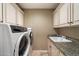 Well-equipped laundry room with updated appliances and ample storage at 2470 E Roma Ave, Phoenix, AZ 85016