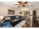 Open-concept living room with dark wood floors, sectional sofa, and seamless flow to the dining area and kitchen at 2470 E Roma Ave, Phoenix, AZ 85016