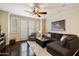 Comfortable living room with a large sectional sofa, shuttered windows, and a ceiling fan for relaxation at 2470 E Roma Ave, Phoenix, AZ 85016