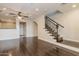 Open-concept living room showcases hardwood floors, staircase with iron railings, and neutral paint at 2470 E Roma Ave, Phoenix, AZ 85016