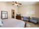 Bright main bedroom with sitting area, ceiling fan, and ensuite bathroom access at 2470 E Roma Ave, Phoenix, AZ 85016