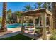 Relaxing pool area with shaded seating under the gazebo and poolside loungers at 2470 E Roma Ave, Phoenix, AZ 85016