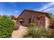 Charming backyard featuring desert landscaping, shrubs, and a covered patio perfect for outdoor living at 2556 W Amber Sun Dr, Phoenix, AZ 85085