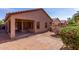 Backyard view showcases a covered patio and lush desert landscaping at 2556 W Amber Sun Dr, Phoenix, AZ 85085