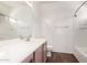 Bright bathroom featuring a large mirror, vanity with neutral cabinets, and shower-tub combo at 2556 W Amber Sun Dr, Phoenix, AZ 85085