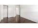 Bedroom featuring modern wood-look flooring, with a closet and a doorway at 2556 W Amber Sun Dr, Phoenix, AZ 85085