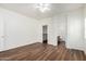 A spacious bedroom with wood-look floors leads to closet and bathroom at 2556 W Amber Sun Dr, Phoenix, AZ 85085