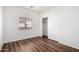 Bright bedroom with wood-look floors and a window with blinds at 2556 W Amber Sun Dr, Phoenix, AZ 85085