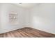 Bright bedroom with a window, and sleek wood-look flooring enhancing the room's appeal at 2556 W Amber Sun Dr, Phoenix, AZ 85085
