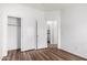 Bedroom featuring modern wood-look flooring, with a closet and an additional doorway at 2556 W Amber Sun Dr, Phoenix, AZ 85085
