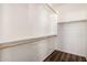 Walk-in closet features wood floors, white walls, and wooden rods and shelves at 2556 W Amber Sun Dr, Phoenix, AZ 85085
