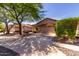Well-maintained single-story home with a manicured front yard and spacious driveway for easy parking at 2556 W Amber Sun Dr, Phoenix, AZ 85085