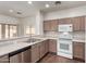 Bright kitchen showcasing modern appliances, neutral countertops, wood-look floors, and updated cabinets at 2556 W Amber Sun Dr, Phoenix, AZ 85085