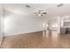 Bright open-concept living room with tile flooring, ceiling fan and easy access to the kitchen at 2556 W Amber Sun Dr, Phoenix, AZ 85085