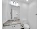 Well-lit bathroom featuring a vanity with granite countertop and a white toilet at 25726 W Burgess Ln, Buckeye, AZ 85326