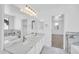 Bright bathroom showcasing double sinks, marble-look countertops, and a large mirror at 25726 W Burgess Ln, Buckeye, AZ 85326