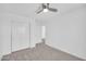 This bedroom includes neutral carpet, and a closet for storage space at 25726 W Burgess Ln, Buckeye, AZ 85326