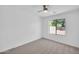 Bright bedroom with neutral carpeting and a view of the backyard at 25726 W Burgess Ln, Buckeye, AZ 85326