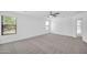 Spacious bedroom features plush carpeting, a ceiling fan, and natural light from the large window at 25726 W Burgess Ln, Buckeye, AZ 85326