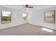 Bright bedroom features neutral carpet and natural light through three large windows at 25726 W Burgess Ln, Buckeye, AZ 85326
