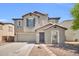 Two-story home with neutral paint, tile roof, landscaped yard, and a two car garage at 25726 W Burgess Ln, Buckeye, AZ 85326