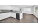Modern kitchen features white cabinets, granite countertops, gray backsplash, and stainless steel appliances at 25726 W Burgess Ln, Buckeye, AZ 85326