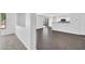 Open-concept living room leads to the modern kitchen and backyard at 25726 W Burgess Ln, Buckeye, AZ 85326